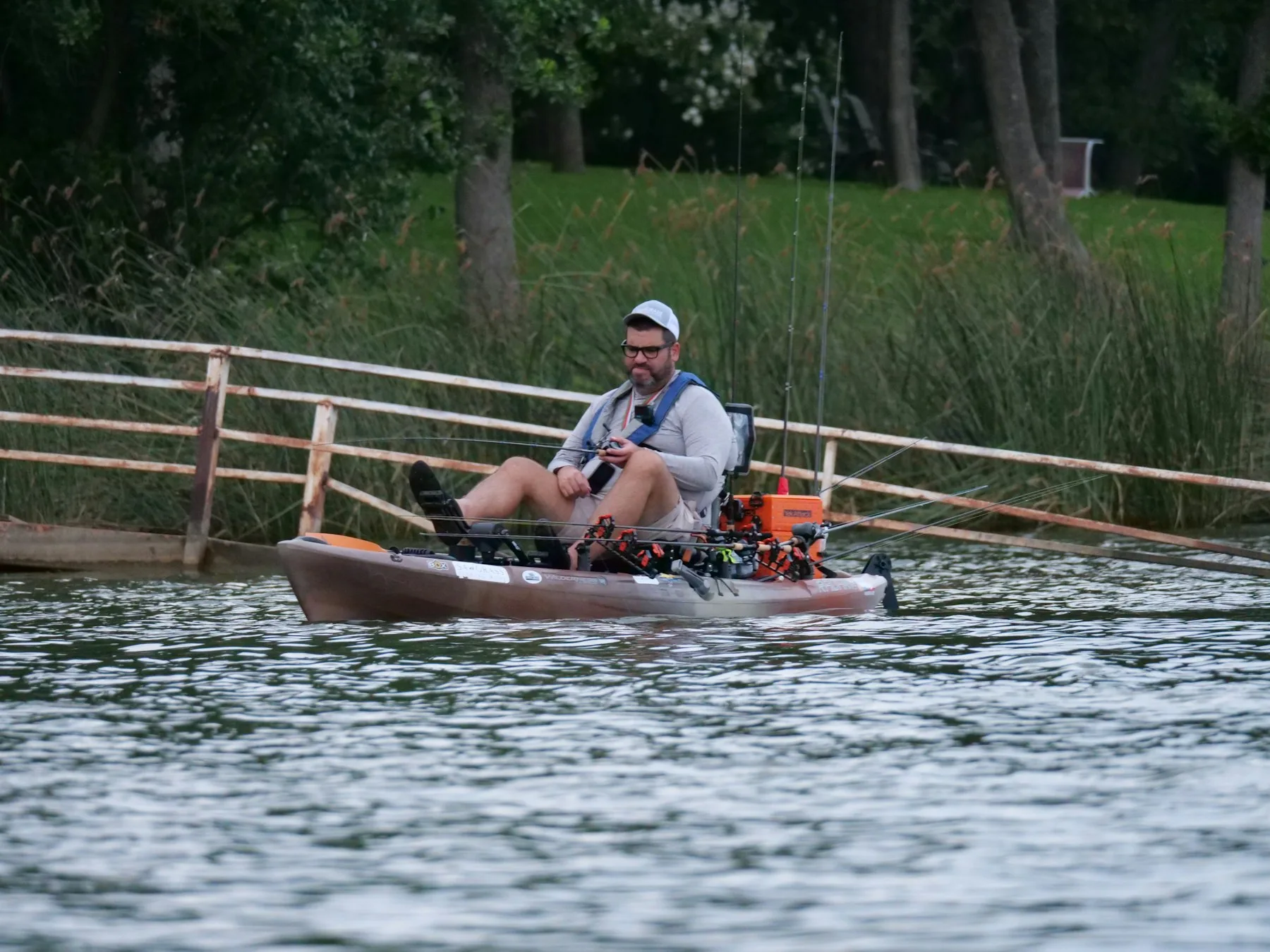 An angler fishing from a kayak on a lake